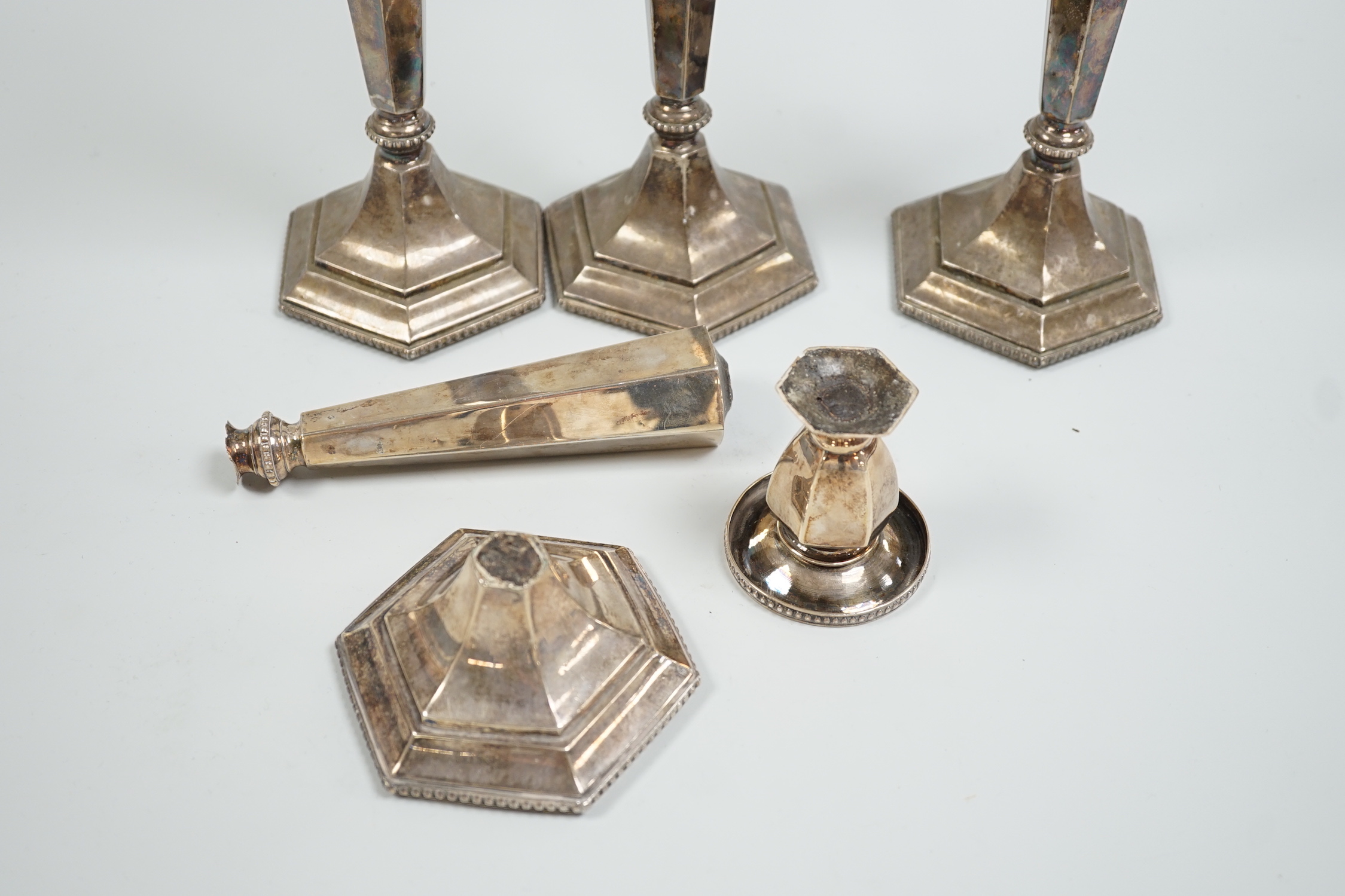 A set of four Chinese Export sterling candlesticks, Tien Tsin, Yeching, one a.f., 26.4cm, weighted.